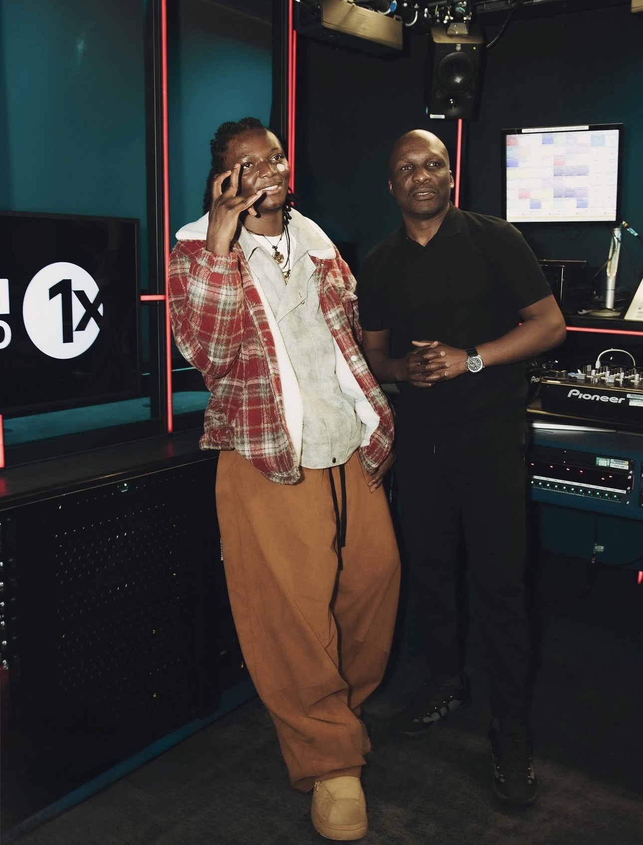 Chella with a presenter in the BBC 1Xtra studio